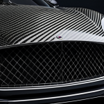 **Prompt:** A sleek, modern car body panel made of visible carbon fiber weave, showcasing its lightweight and high-strength properties. Emphasize the intricate design and the use of carbon fiber in automotive engineering, highlighting its benefits for performance.